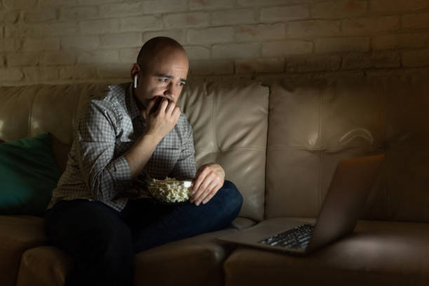 istock Man biting his nails while watching a movie 1222495874