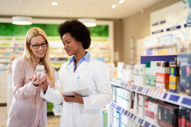 istock Pharmacist helping happy costumer. 1222500360