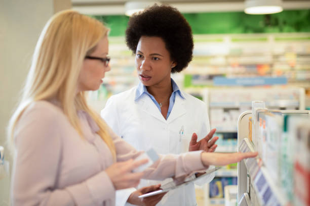 istock Pharmacist helping a costumer at Pharmacy. 1222500379
