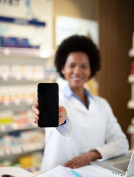 istock Pharmacist holding a smart phone. 1222500402
