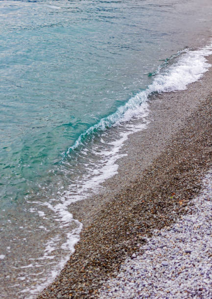 istock Calm sea surf on beach with pebbles 1222501147