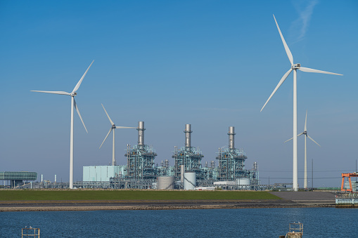 Modern multi-fuel power station and wind turbines at seaport Eemshaven.