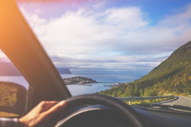 Driving a car on a mountain road on Senja island, view from the windshield. Road to Husoy, Senja, Norway Driving a car on a mountain road on Senja island, view from the windshield. Road to Husoy, Senja, Norway senja island photos stock pictures, royalty-free photos & images