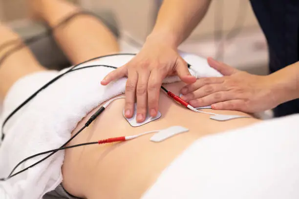 Photo of Electro stimulation in physical therapy to a young woman