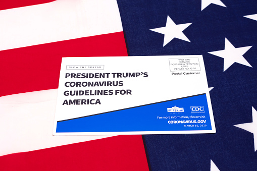 President Trump's coronavirus guidelines for America official postcard on the flag of the United States of America - San Jose, CA, USA - March 16, 2020