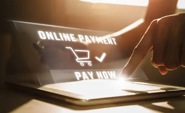 Online payment concept, Man using tablet computer and holding credit card at working desk. Banking and online shopping.