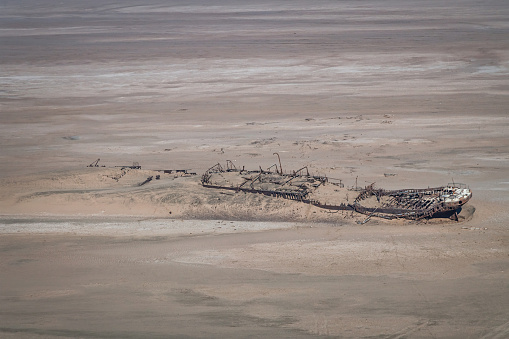 Abandoned old historic shipwreck covered from sand dunes in the skeleton coast desert. Aerial View , shot from cessna flyover along the Namibian Skeleton Coast Desert, Nambia, South West Africa, Africa