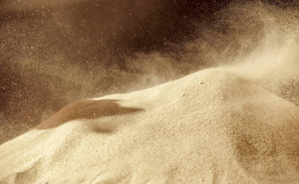 Pile of sand explosion, Sandy fly wave over dark background.