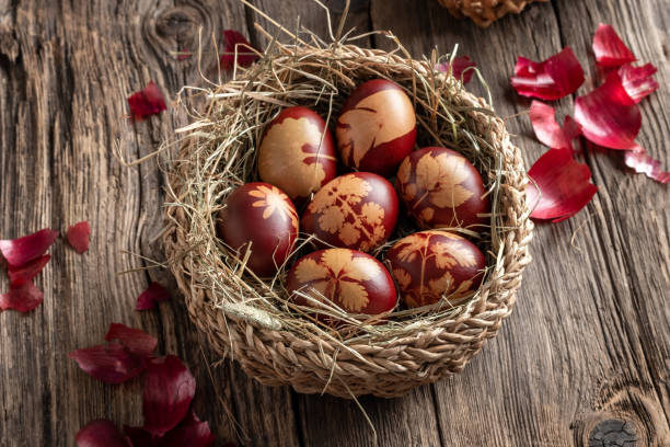 istock Easter eggs dyed with onion peels with a pattern of leaves in a basket 1222520299