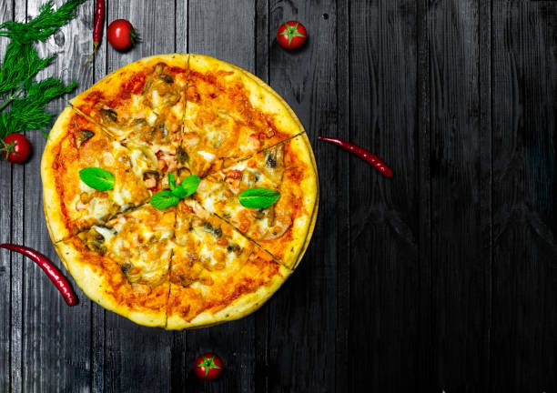 istock Pizza  on a black wooden board 1222520678