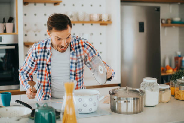 istock Smiling young man in kitchen stock photo 1222522642