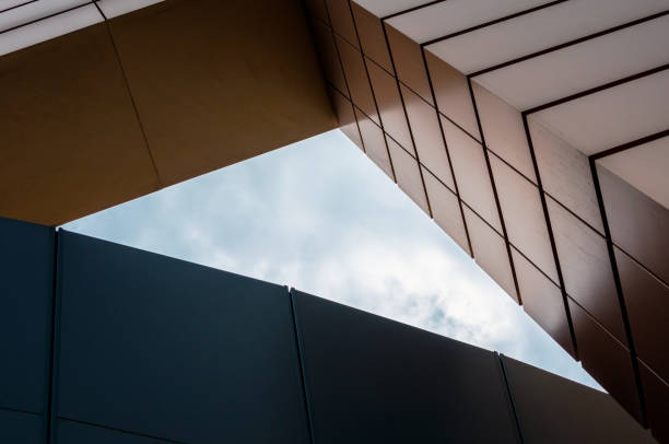 istock blue sky with clouds between the walls of a modern office building 1222523758