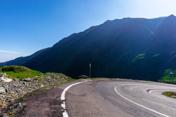 istock winding mountain road on a sunny day 1222525254