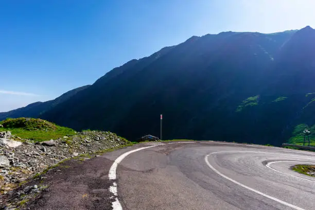 Photo of winding mountain road on a sunny day