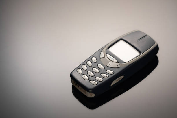 istock An outdated mobile phone with a screen for copying space on a gray gradient background. The minimalist trend. smartphone. with copy space for text 1222530009