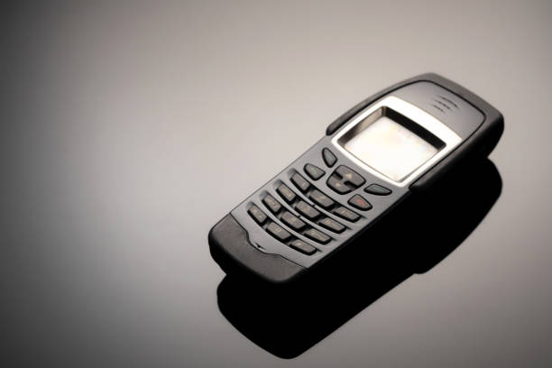 istock An outdated mobile phone with a screen for copying space on a gray gradient background. The minimalist trend. smartphone. with copy space for text 1222530865