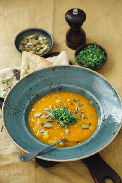 Vegan Pumpkin and Carrot Soup on yellow tablecloth