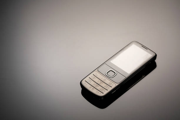 istock An outdated mobile phone with a screen for copying space on a gray gradient background. The minimalist trend. smartphone. with copy space for text 1222531886
