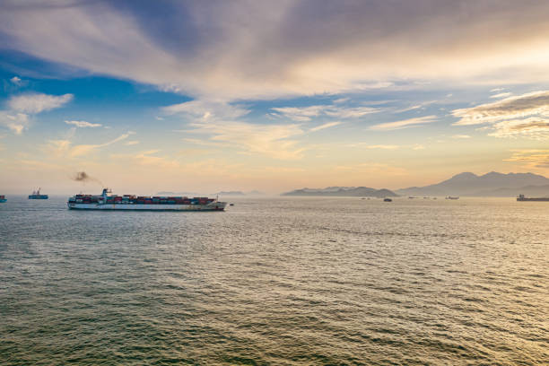 istock Container ships pass in and out Victoria Harbour at dusk 1222532020