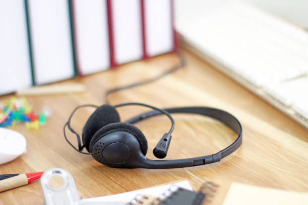 istock Workspace with headset and office equipments on wood desk work background 1222532137