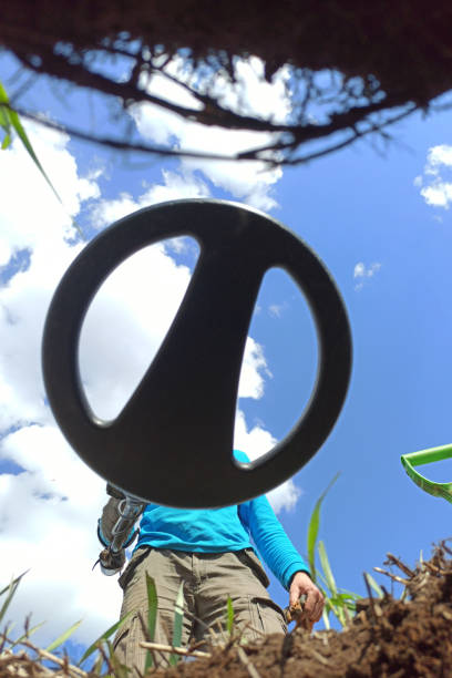istock close-up of a metal detector with a treasure hunter from a digging hole 1222533162