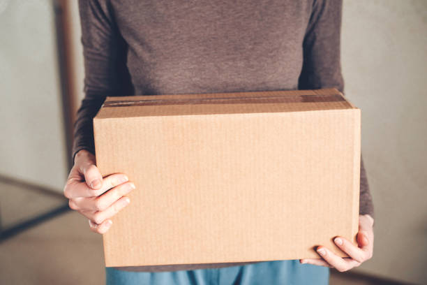 istock Women's hands hold the box with the delivered order. 1222533324