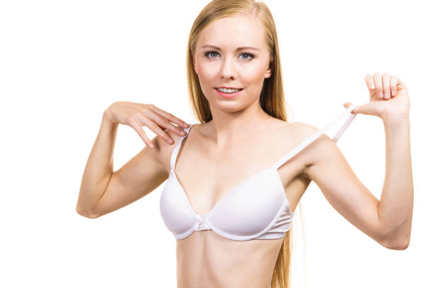 istock Young woman holding bra strap 1222534163