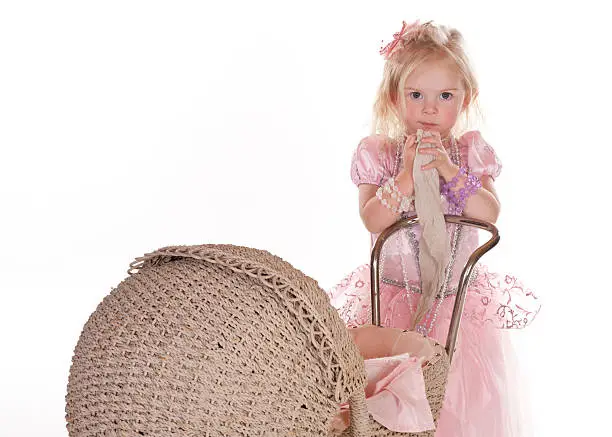 beautiful little girl, her pram and her blankie against white background