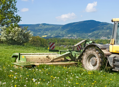 Tractor cutting grass.