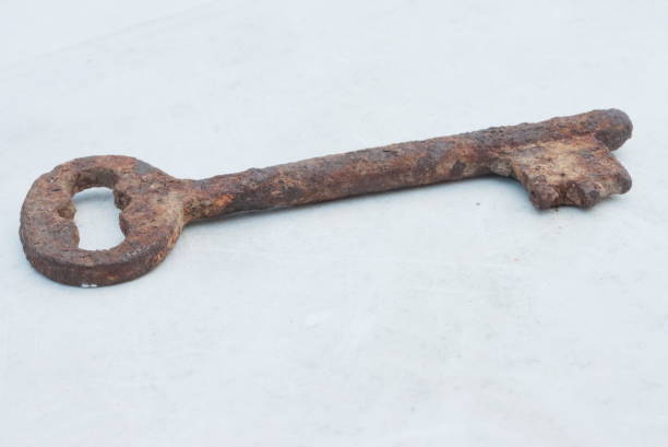 istock Key with a lock on an old shabby door 1222536420
