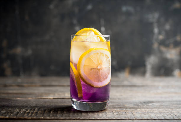 istock Gin based colorful cocktail with lemon and lavender liqueur on the rustic background 1222537088