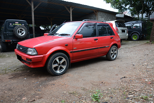 Semarang, Indonesia - February 9, 2019: Toyota Starlet EP 71 1988 series with 1300cc engine parked on the curb of a building in Semarang, Indonesia