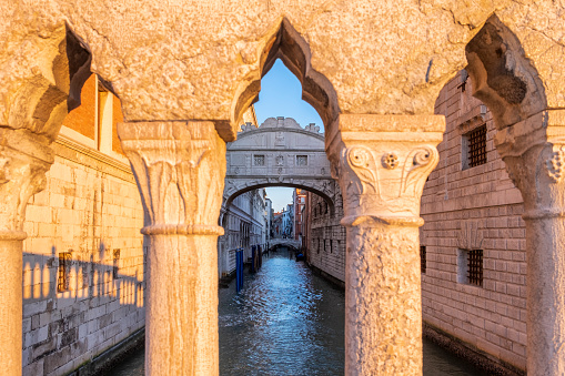 The famous Bridge of Sighs, which connects The Doge's Palace to the New Prisons building, framed in the arches of the Ponte della Paglia in Venice