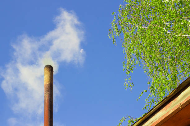 istock smoke from a steel pipe against a blue sky with the moon 1222539125