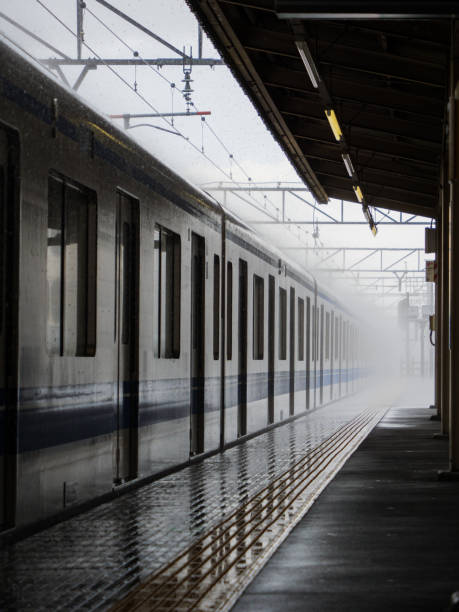 Tokyo, Japan - 27 8 19: A train arriving at the platform in very heavy rain