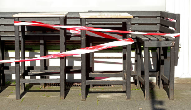 Shut-off tape, empty chairs and tables of a cafe closed due to coronavirus, Bremen, Germany, Europe stock photo