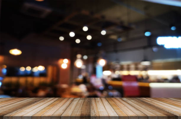 istock wooden table with abstract blurred background resturant lights used for display montage products mock up design. 1222539697