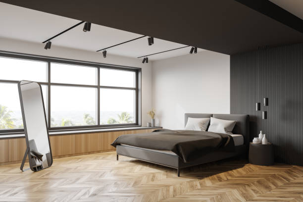 istock White and gray bedroom corner, mirror and window 1222540484