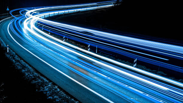 istock blue car lights at night. long exposure 1222540782