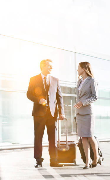 istock Business people talking while walking with their suitcase in airport 1222541168