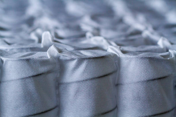 Independent mattress springs in spunbond. Pocket springs. Independent mattress springs in spunbond. Pocket springs coiled spring stock pictures, royalty-free photos & images