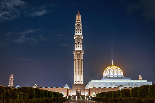 Illuminated Sultan Qaboos Grand Mosque shining at Night. Wide Angle Architecture Shot. Muscat, Oman, Middle East