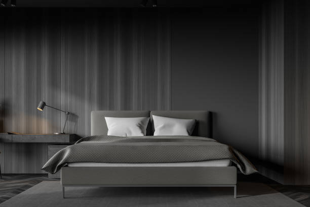 istock Dark wooden master bedroom with table 1222542402