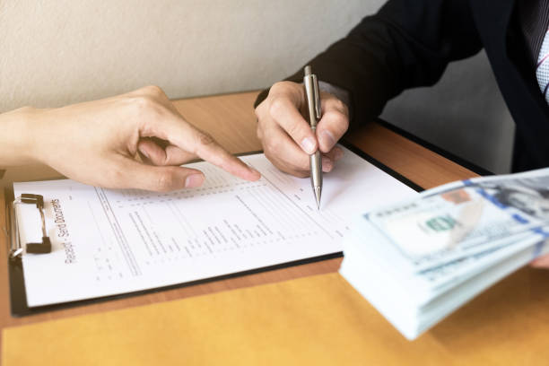 istock The businessman signed a contract agreement documents and receive a bribe from another businessman sitting in front at the office. 1222543312