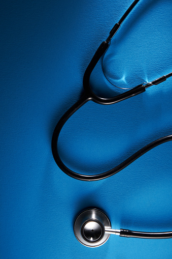 stethoscope on blue background with copy space