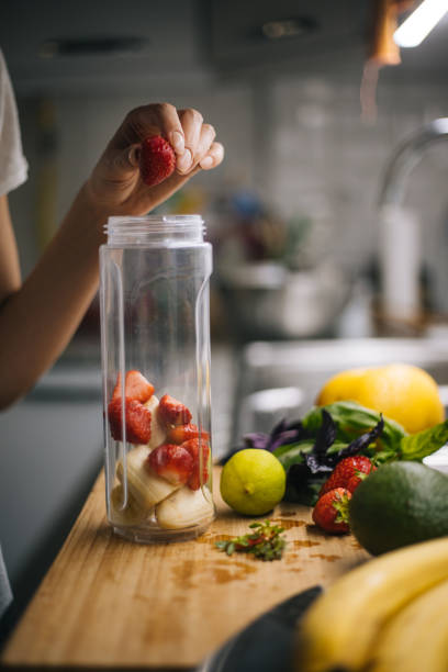 istock Woman making smoothie in kitchen 1222546358