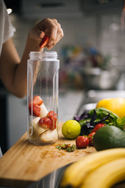 istock Woman making smoothie in kitchen 1222546400