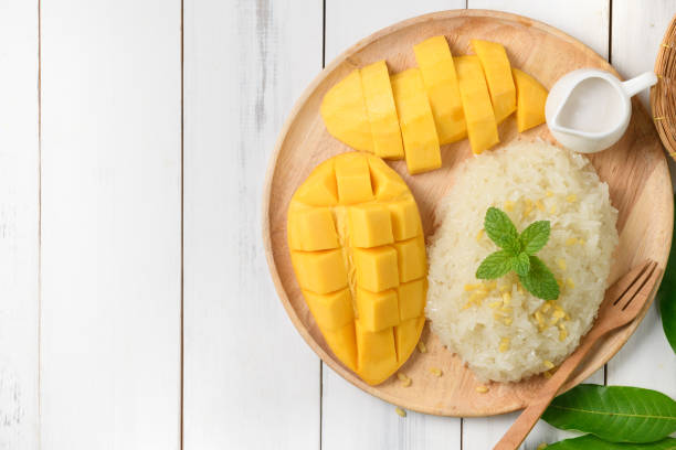 istock Ripe mango and sticky rice with coconut milk on white wood background 1222546619