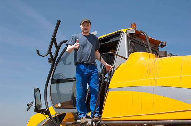 istock Driver of machinery sprayer expresses agreement. 122254720