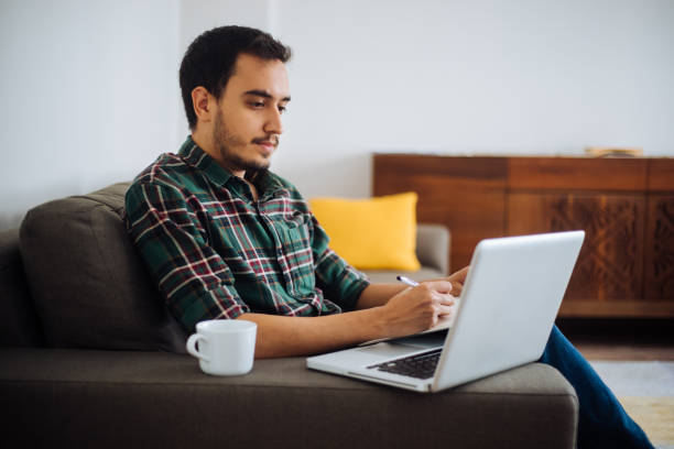 istock Young man working in his home office 1222548088